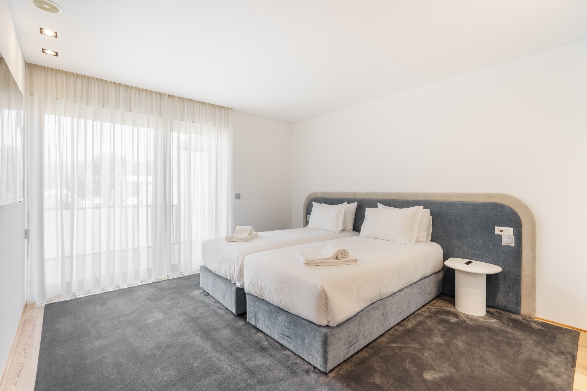 Twin Room — two single beds joinable into a super-king, soft grey headboard.