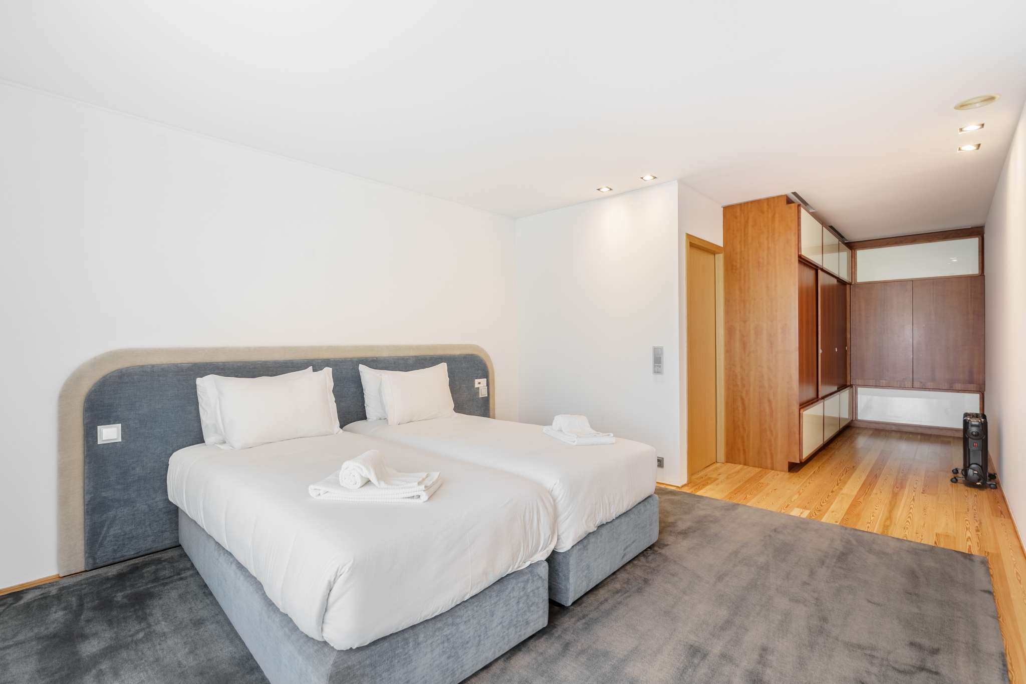 Twin Room — twin beds with wood wardrobes alongside.
