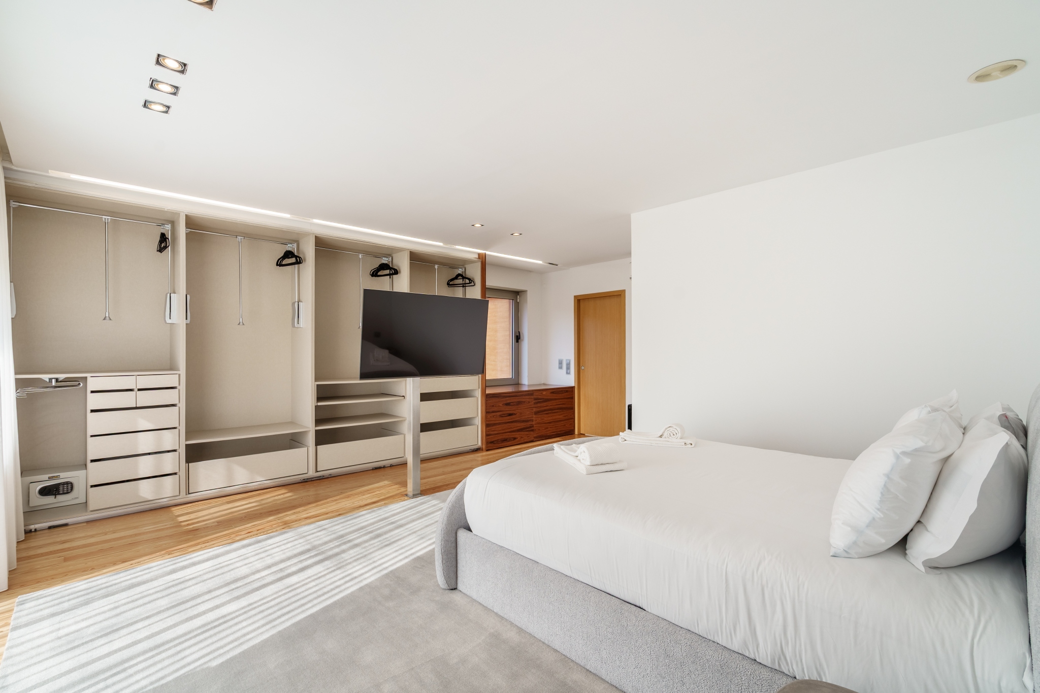 Garden Suite — walk-in dressing room with open wardrobe and safe.