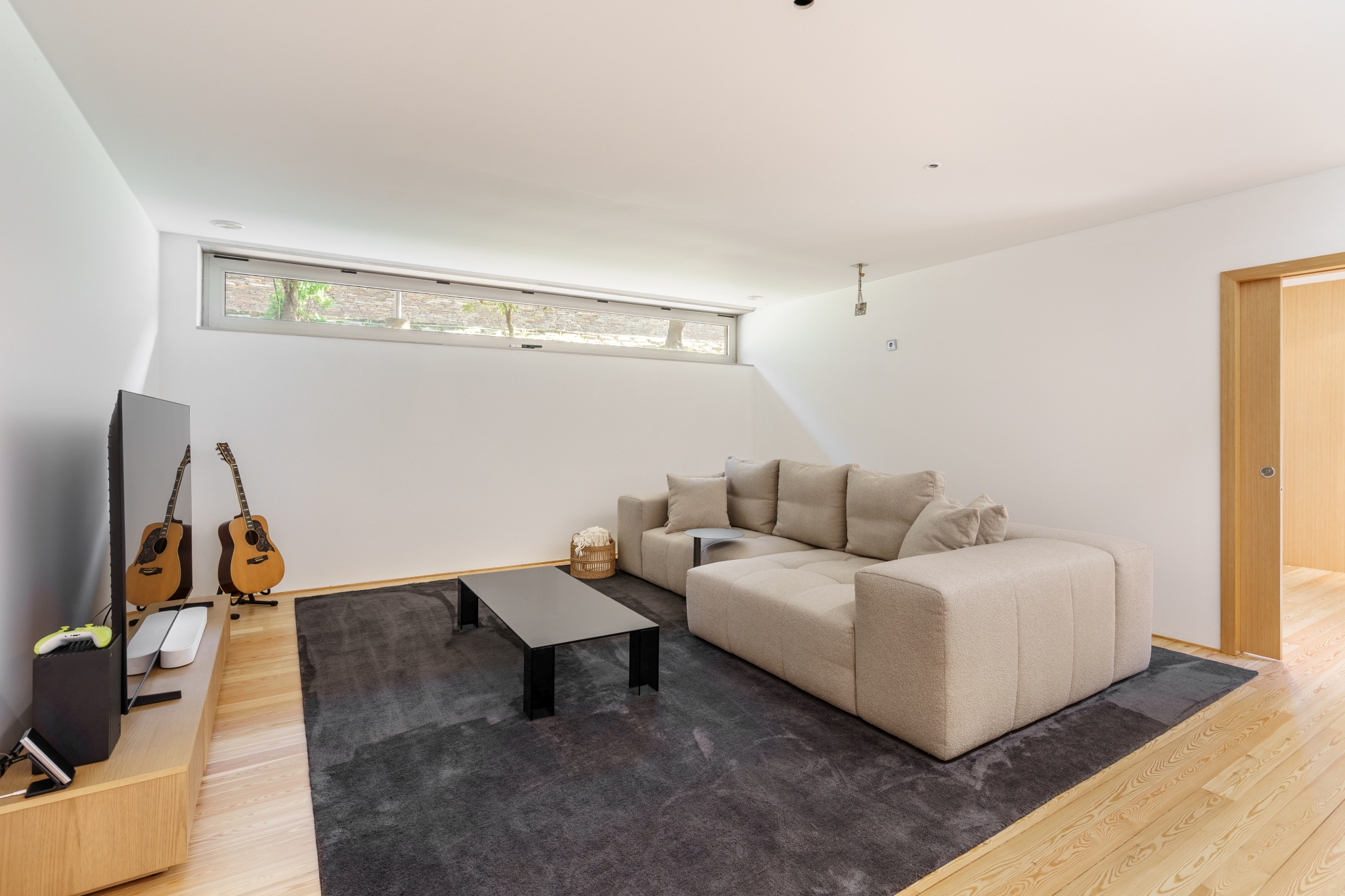 Pool Suite — the private cinema lounge, deep sofa and screen.