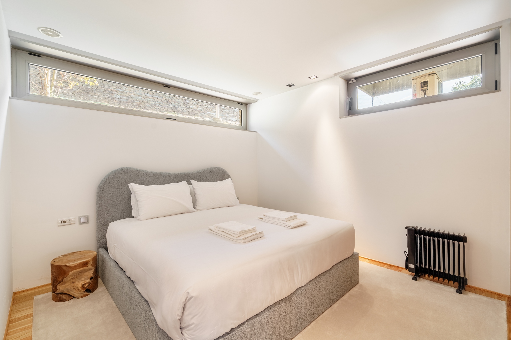 Pool Suite — garden-level bedroom with clerestory light.