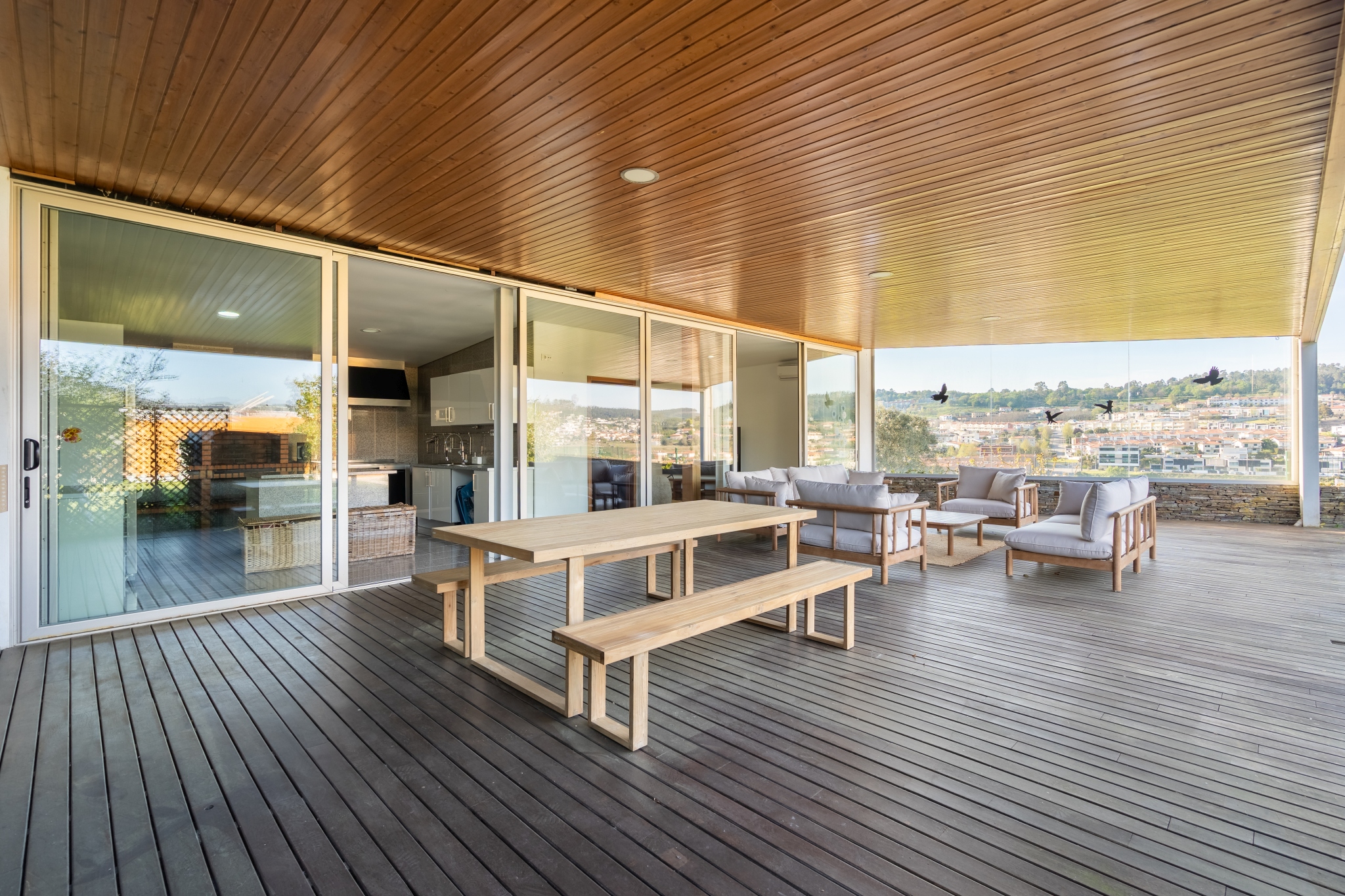 The Guest House — covered terrace with a long table and the valley view.