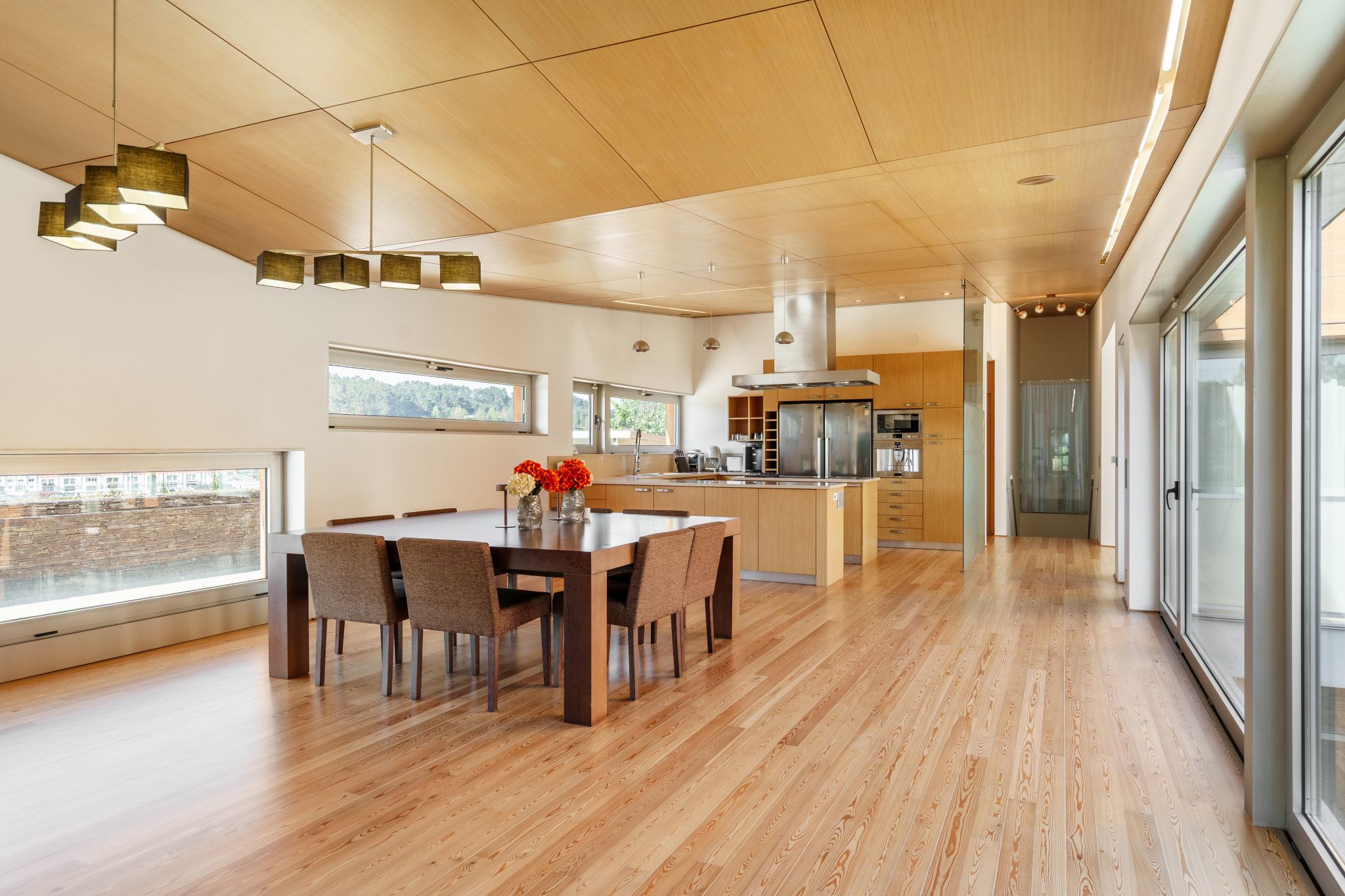 The kitchen and dining room of Matos Essence Villa — bamboo ceiling, long table, valley views.