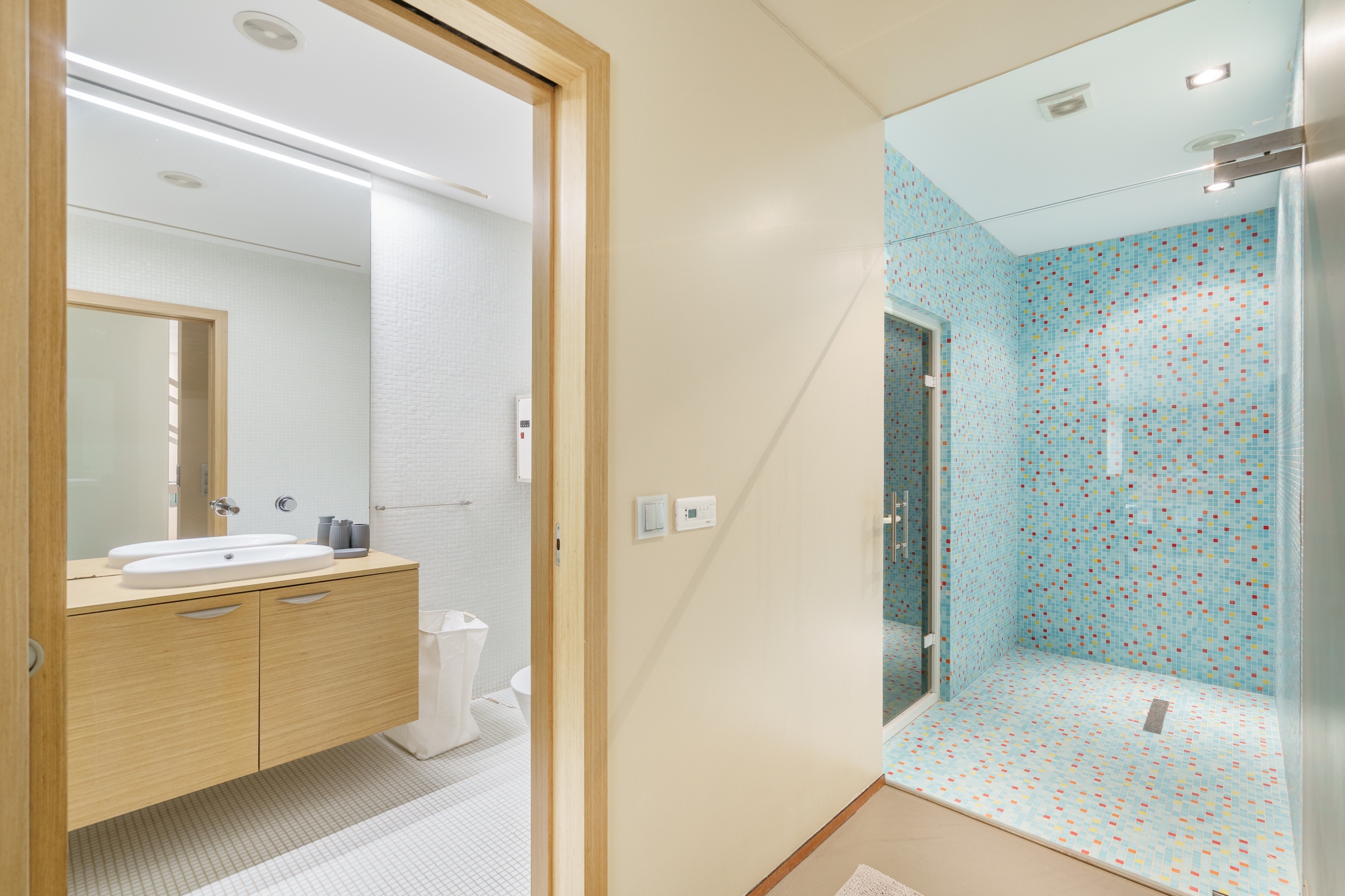 Steam room with blue mosaic tile.